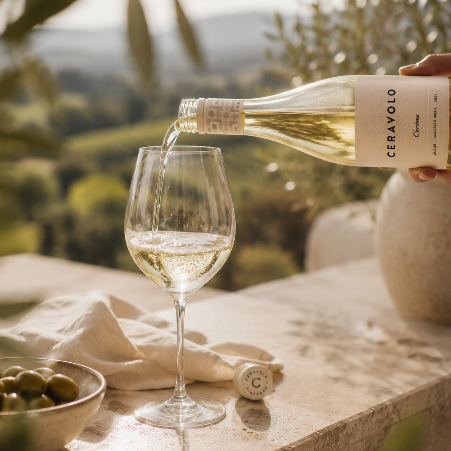 Glass of Ceravolo white wine on an outdoor table overlooking the Adelaide Hills.